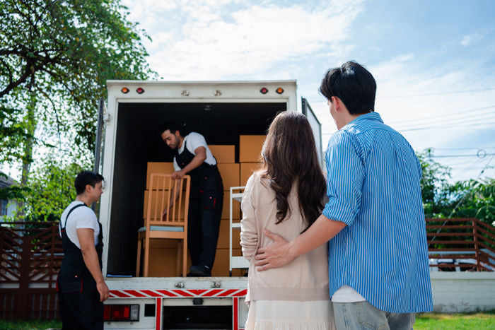 Couple Receiving A Furniture Delivery