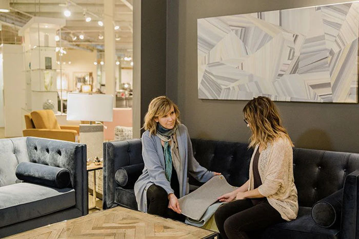 Two Women Discussing Styles in A Furniture Store
